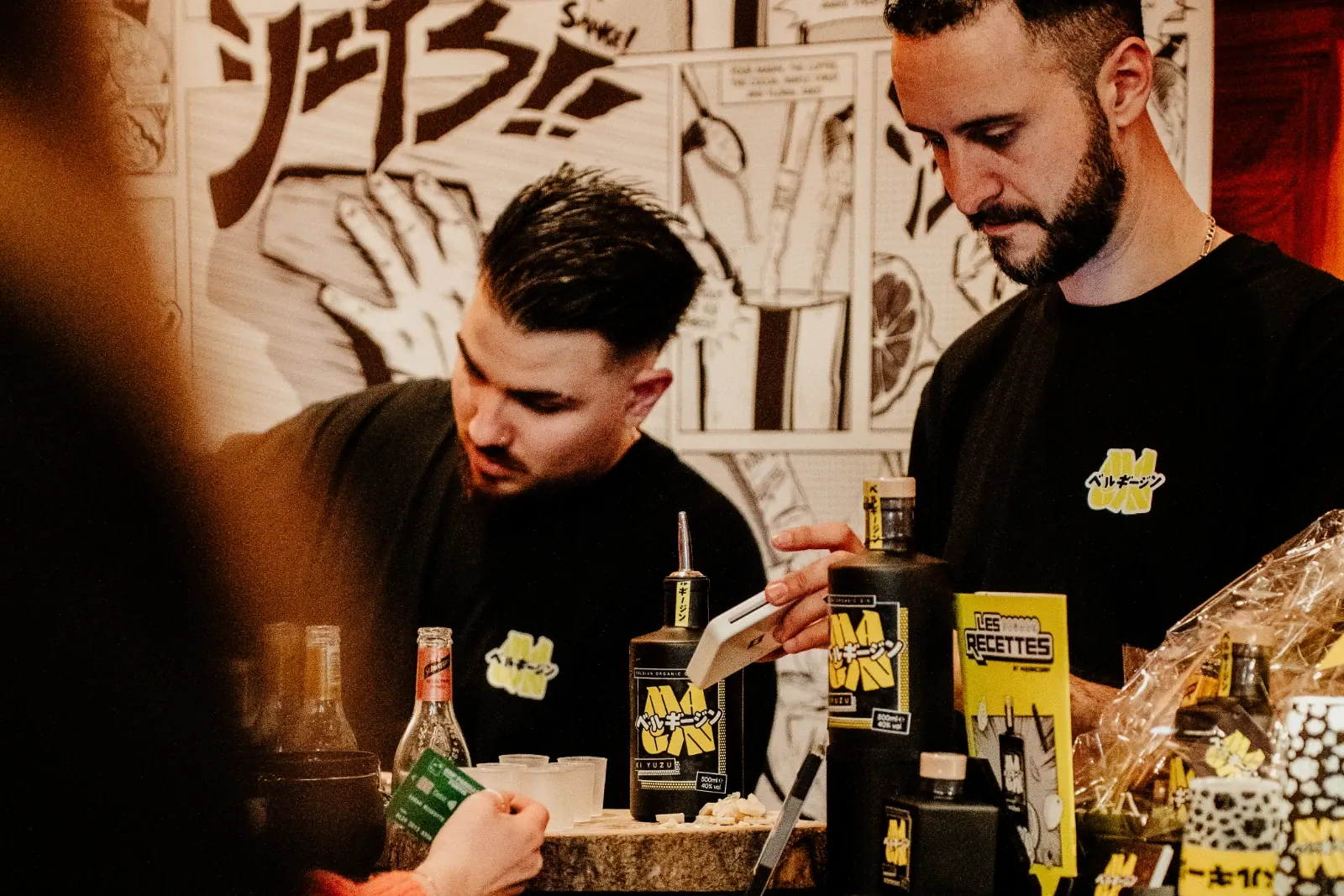 Two members of the MaGin Team serving behind the stand